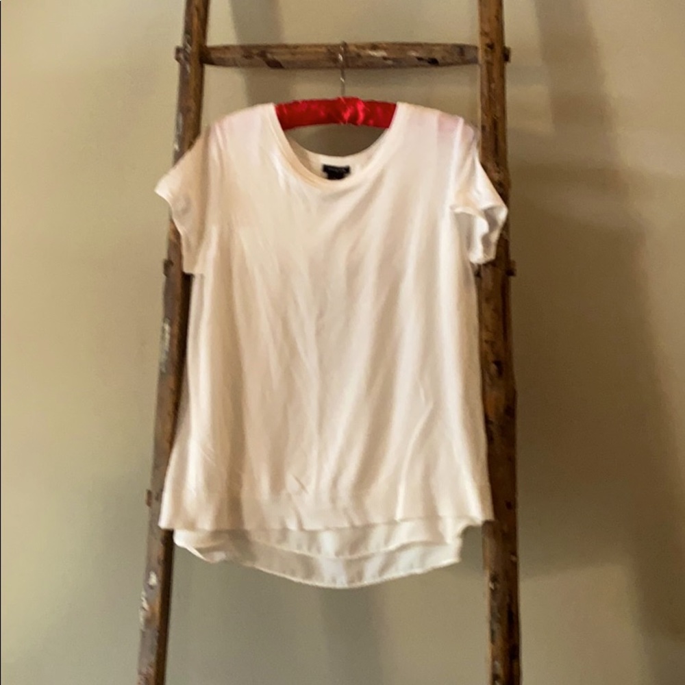 Off white short sleeved sweater with open back.